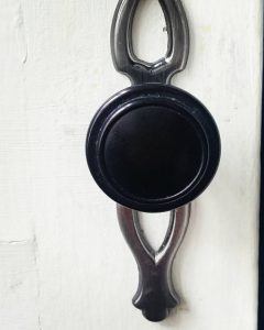 black door handle, white door