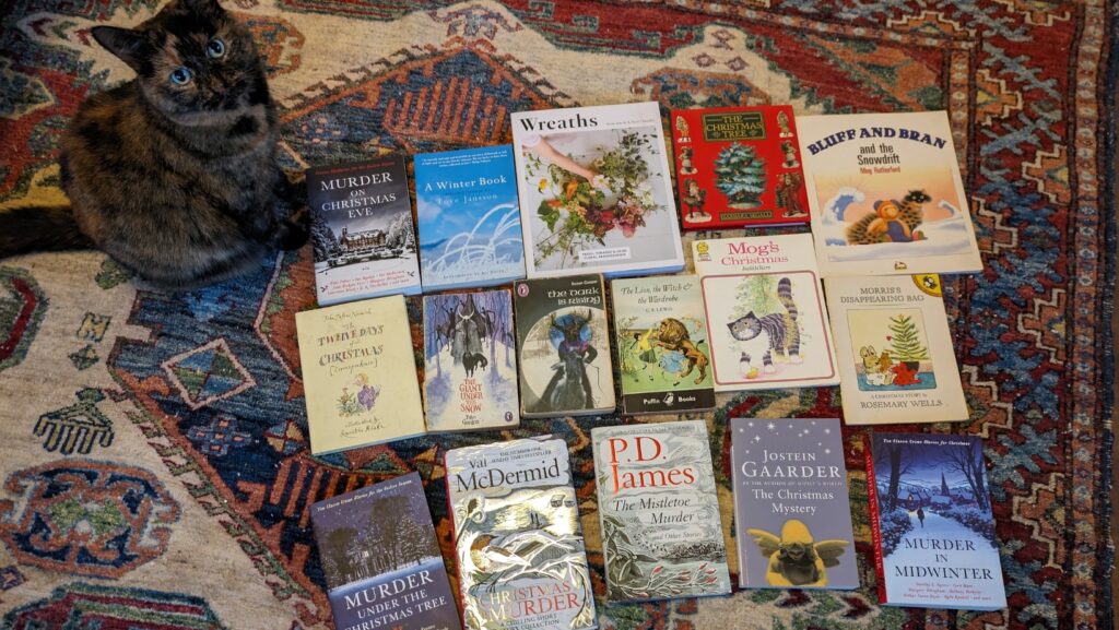 seasonal books for Christmas blog banner, Mulan, tortoiseshell cat, colourful rug