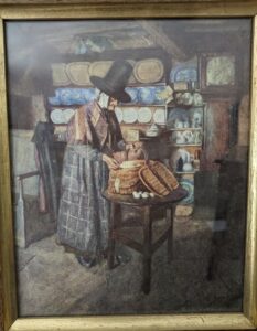 cottage interior, welsh dressersian owen, sian owen, wearing a welsh lady costume with woollen shawl, artist sydney curnow vosper; market day, this is a photo of a print we have, 1910